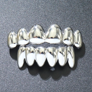 Detailed macro view of silver polished vampire teeth grillz for upper and lower teeth set