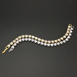 Close-up of gold and silver heart-shaped tennis bracelets with shimmering crystals