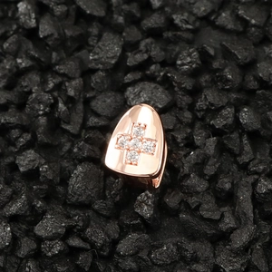 Macro view of rose gold hip hop teeth grillz with cross pattern and cubic zirconia