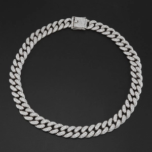 Detailed macro view of 15mm iced out silver cuban link chain with paved diamonds clasp