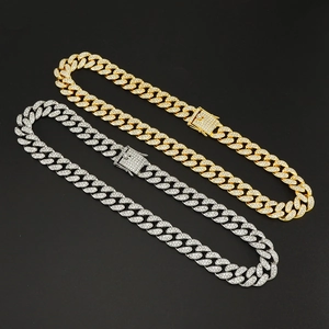 Close-up of gold and silver 15mm Miami Cuban link necklaces with shiny full diamond plating