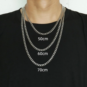 Three-length silver Cuban chain set in 50cm, 60cm, and 70cm worn on a black shirt