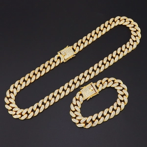 Golden iced out Cuban link chain necklace and bracelet set with sparkling rhinestones