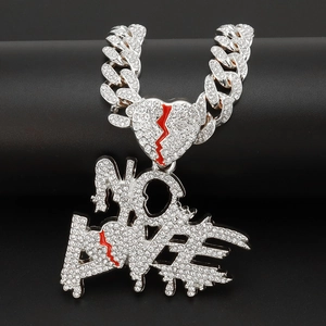 Macro shot of hip-hop No Love pendant with red broken hearts and crystal Cuban chain