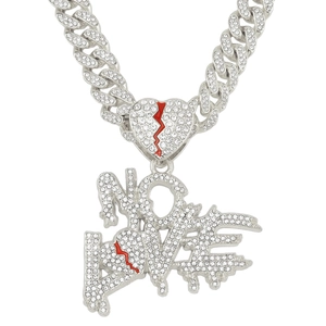 Macro detail of iced out silver Cuban chain necklace with NO LOVE broken heart pendants