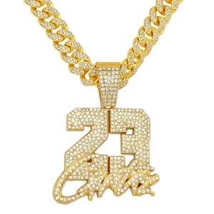 Macro view of iced-out gold Cuban link necklace with crystal encrusted number 23 and James pendant
