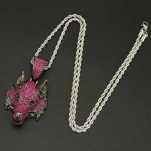 Macro detail of hip hop wolf head pendant with pink rhinestones and silver rope chain