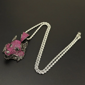 Macro detail of hip hop wolf head pendant with pink rhinestones and silver rope chain