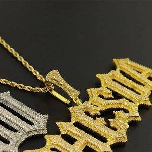 Macro detail of iced-out hip hop pendants with cubic zirconia on gold rope chain