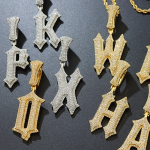 Detailed macro shot of 3D gothic initial pendants with pavé-set sparkling zircons