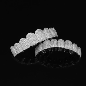 Macro detail of silver hip hop grillz set with high-density cubic zirconia stones