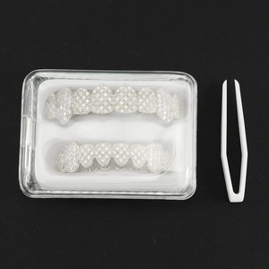 Silver grillz teeth set with cubic zirconia stones, including case and tweezers
