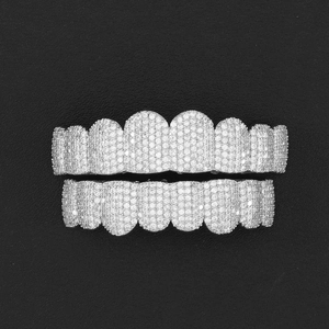 Macro detail of hip hop silver grillz set fully encrusted with white zirconia stones