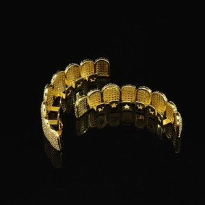 Hip hop gold teeth grillz set with zircon inlays and star hollow design on black background