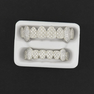 Hip hop silver teeth grillz set with clear zircon stones on black leather background