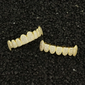 Hip hop gold plated grillz set with sparkling cubic zirconia on a black background