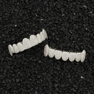 Detailed macro view of hip hop silver teeth grills set with sparkling micro pave zircons