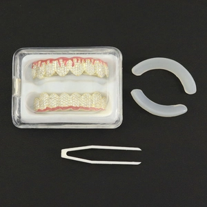 Hip hop style gold grillz set with red enamel blood drip design and diamond accents
