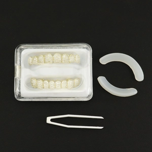 Detailed hip-hop grillz set with cubic zirconia teeth, silicone strips, and tweezers