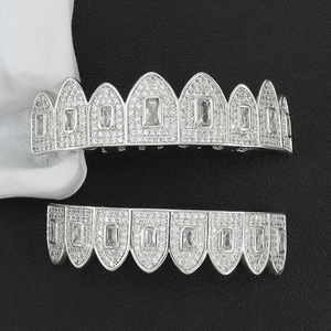 Macro detail of silver plated hip hop grillz featuring micro paved cubic zirconia stones