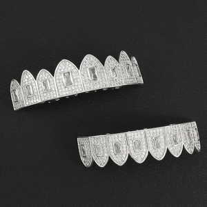 Macro detail of silver hip-hop grillz set with baguette-cut and pave zircon stones