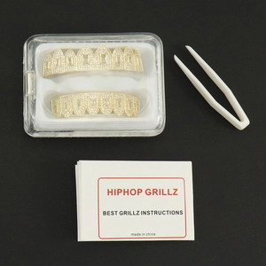 Golden hip hop grillz set with sparkling zircon stones including tweezers and storage box