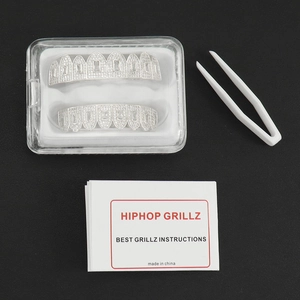 Iced out hip hop grillz set with silver metal and zircons including storage case and tweezers