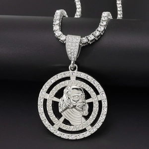 Macro shot of silver hip hop necklace with portrait pendant and tennis chain detail