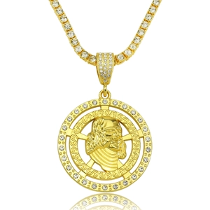 Hip hop gold necklace with portrait disc pendant and sparkling tennis chain on white surface
