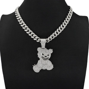 Macro view of silver hip hop bear pendant set with crystals on a thick cuban chain