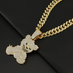 Close-up of hip-hop bear pendant with full cubic zirconia stones on gold Cuban chain