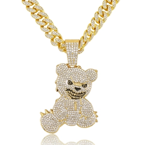 Hiphop gold Cuban chain with iced out diamond teddy bear pendant on white background