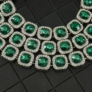 Macro shot of 13mm emerald green square crystals on heavy duty luxury cuban link bracelet