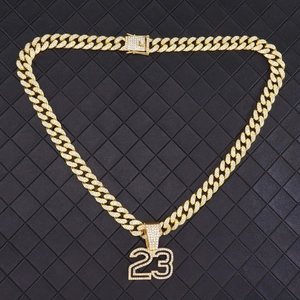 Iced out gold Cuban chain with diamond encrusted number 23 pendant on black leather