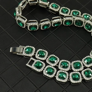 Detail view of 13mm green square-cut crystals on a silver hip-hop Cuban link bracelet