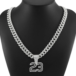 Detail of silver Cuban link chain and number 23 pendant with shiny rhinestone pavé