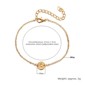 Detail of adjustable golden alloy bracelet with a 10mm round letter C pendant charm