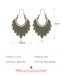 Detail view of antique bronze feather earrings with dimensions 5cm height and 3.5cm width