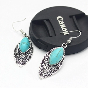 Vintage alloy teardrop earrings with turquoise stone and antique floral carvings