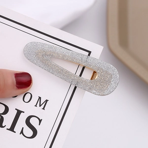 Detail of silver glitter water-drop BB hair clip with non-slip metal teeth and shiny finish