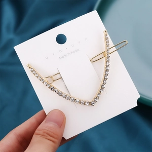 Elegant V-shaped gold metal hair clip with sparkling rhinestones for sophisticated styling