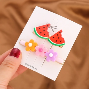 Cute two-piece hair clip set featuring watermelon slices and colorful floral designs