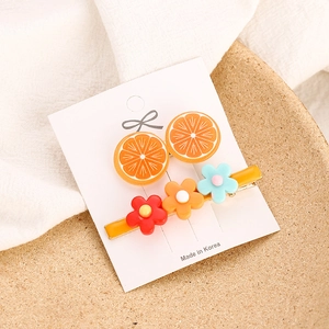 Sweet 2-piece hair clip set featuring resin orange slices and colorful flower designs