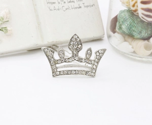 Macro detail of a silver alloy crown hairclip with sparkling crystal rhinestones