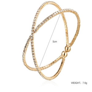 Macro detail of gold-plated crossover bangle with crystals and 5cm inner diameter specs