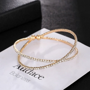 Fashionable gold-plated criss-cross open bangle with sparkling pavé cubic zirconia accents