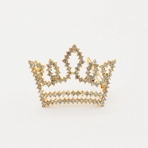 Elegant gold crown hair clip with sparkling crystals in a minimalist princess design