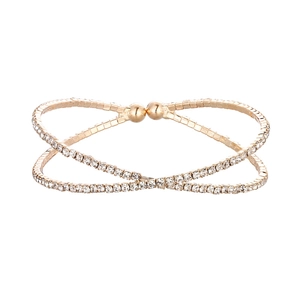 Chic gold-plated crossover bangle with shimmering pavé crystal accents and ball tips