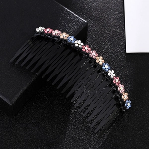 Detail of colorful crystal plum blossom hair comb with sparkling rhinestones set on black