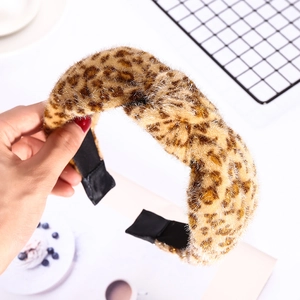 Faux fur leopard print headband with stylish top knot design for winter fashion styling